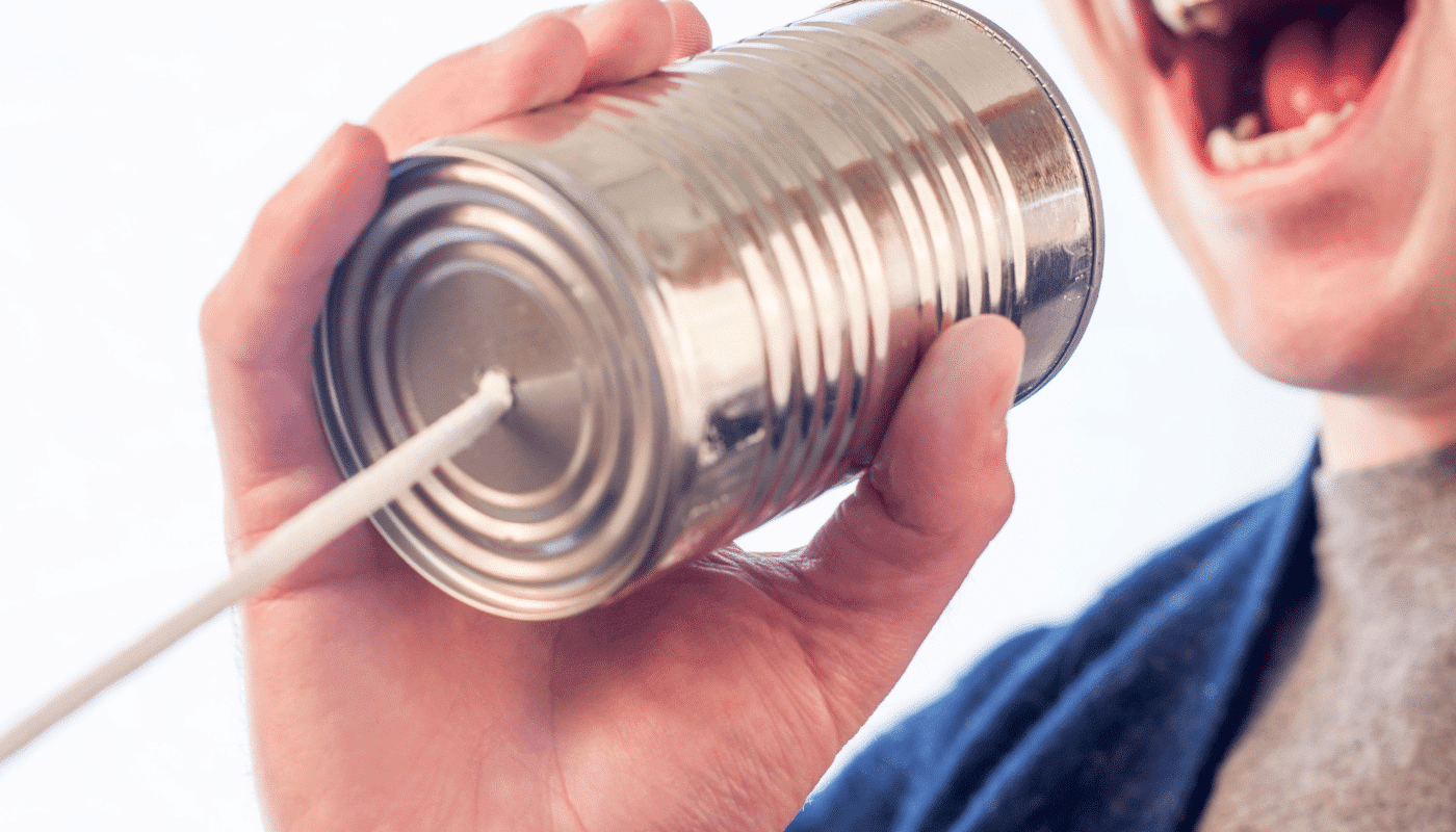 person speaking into tin can with cord